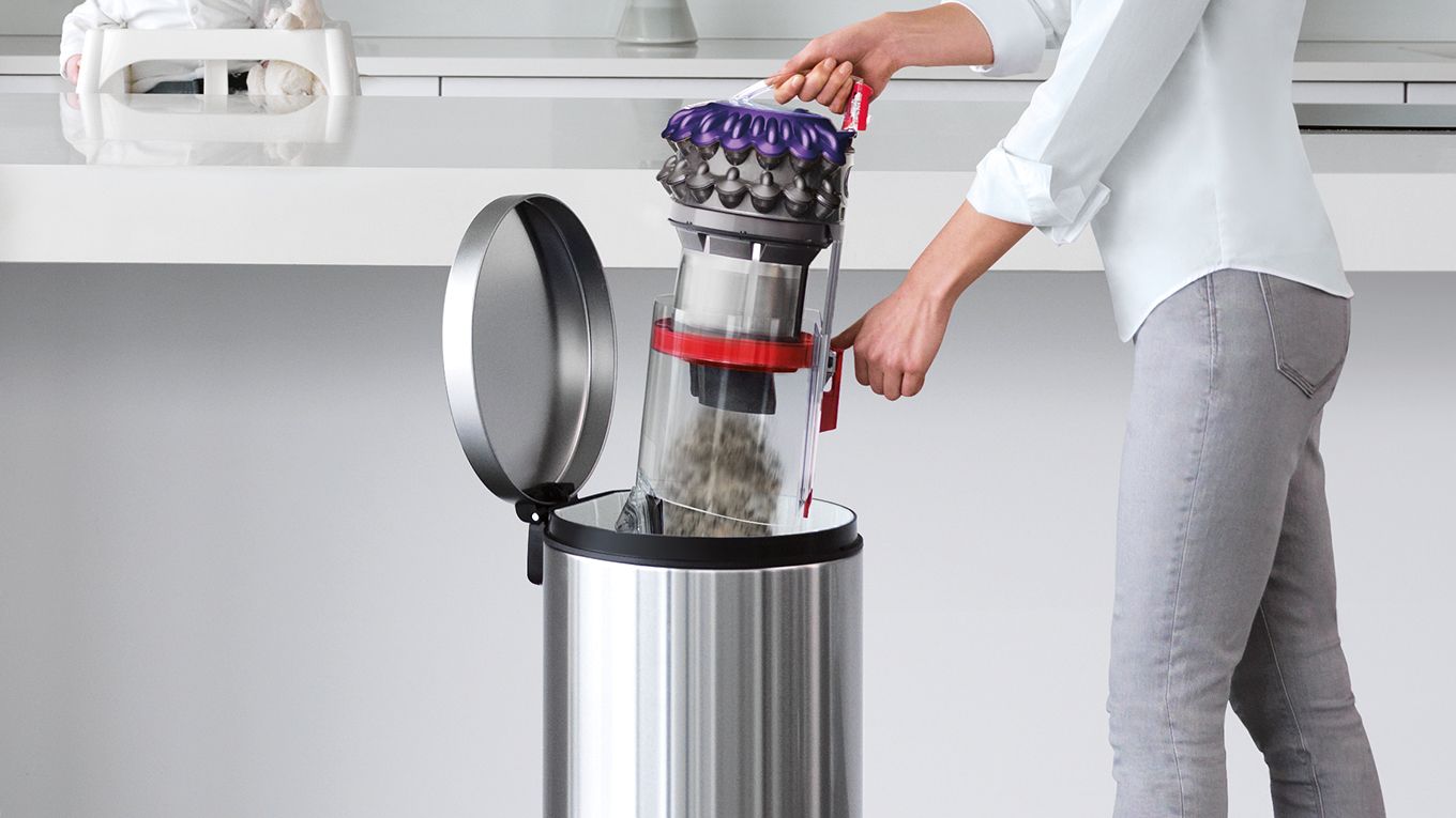 Aspirateur Dyson Big Ball en train d’être vidé dans une poubelle. Aspirateur Dyson Big Ball en train d’être vidé dans une poubelle.